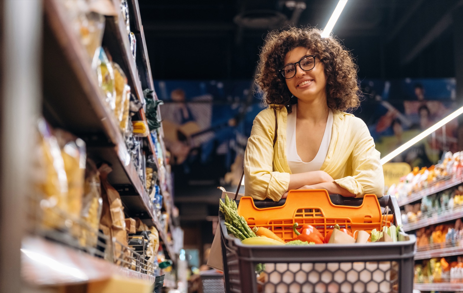 A shopper browsing grocery shelves