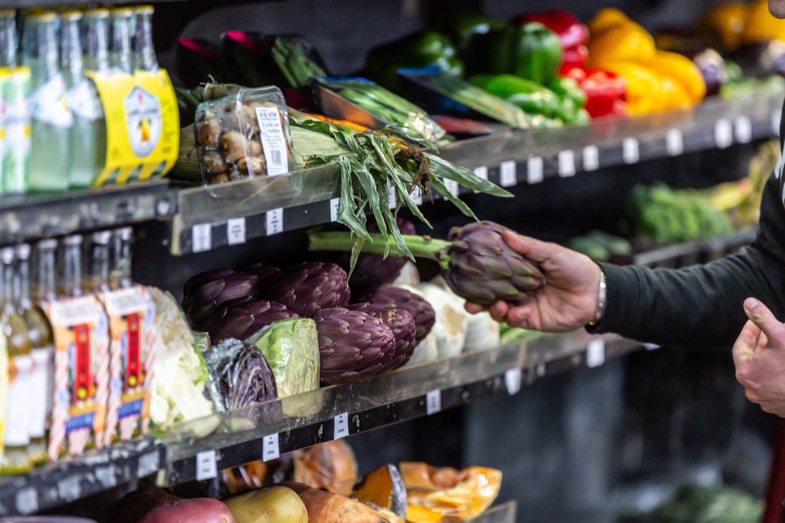 A hand choosing fresh produce